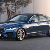 A blue 2021 Jaguar XF in front of a white building