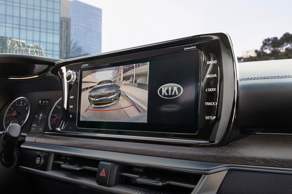 A close-up of the 2021 Kia K5 EX's touchscreen with the rearview camera displayed