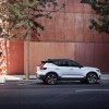 A white and black 2021 Volvo XC40 R-Design parked next to the side of a building