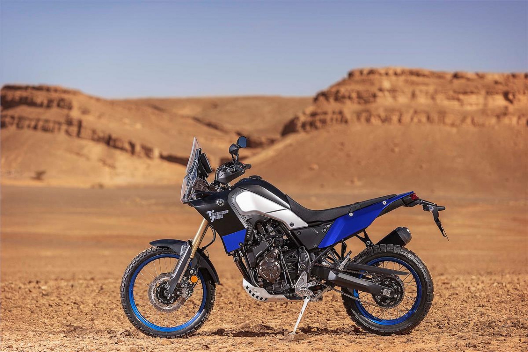 A blue 2021 Yamaha Ténéré 700 by the desert landscape