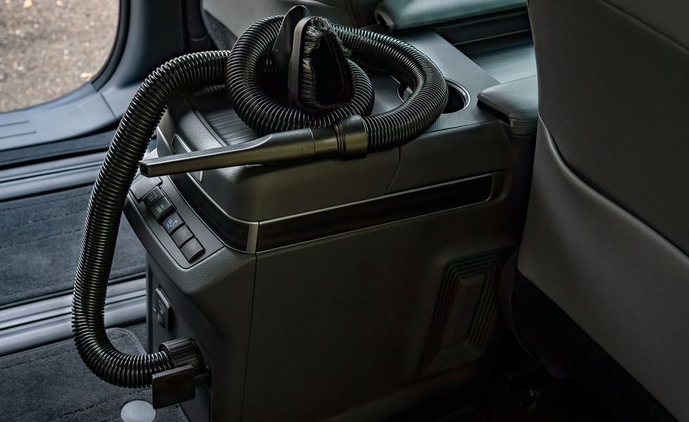 A Sienna van with an in-car vacuum in the console area.