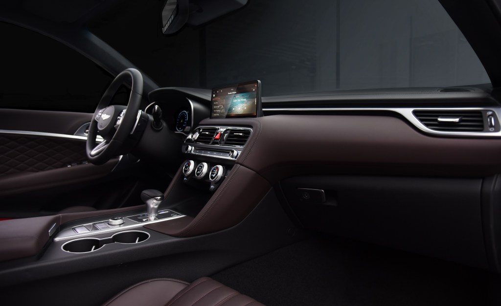 Interior shot of 2022 Genesis G70 sedan showing steering wheel, infotainment screen, and center console