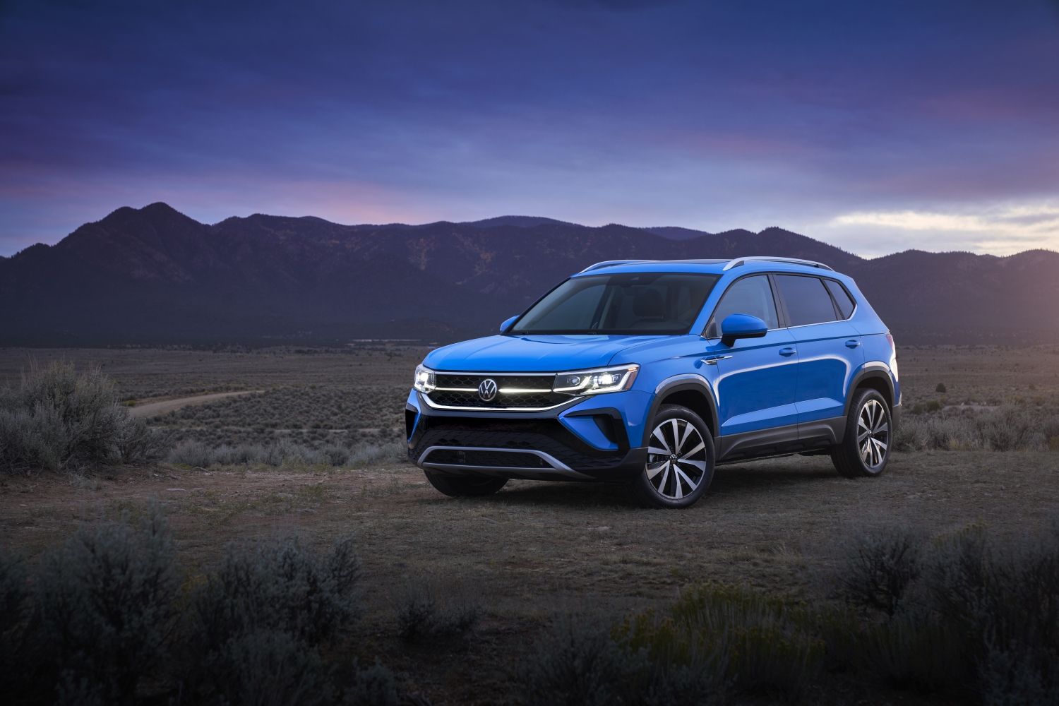 Press image of a blue 2022 Volkswagen Taos in the desert