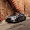 a Celestite 2020 Toyota Corolla XSE parked in the city in front of a red brick wall