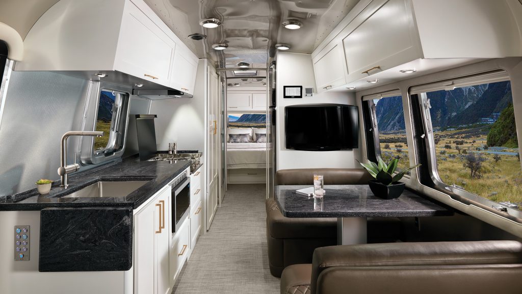 A Airstream Classic with a white cafe latte color kitchen area. 
