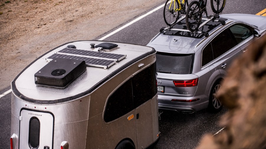 elevated view of an Airstream basecamp RV being towed by a silver audi SUV