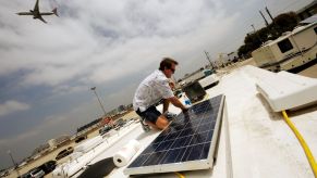 An aircraft mechanic does maintenance work on his RV's solar panels