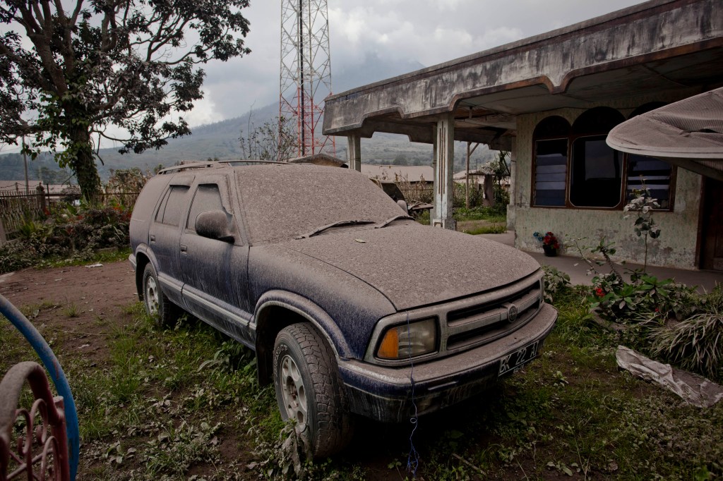 Volcanic ash covers an SUV in Indonesia
