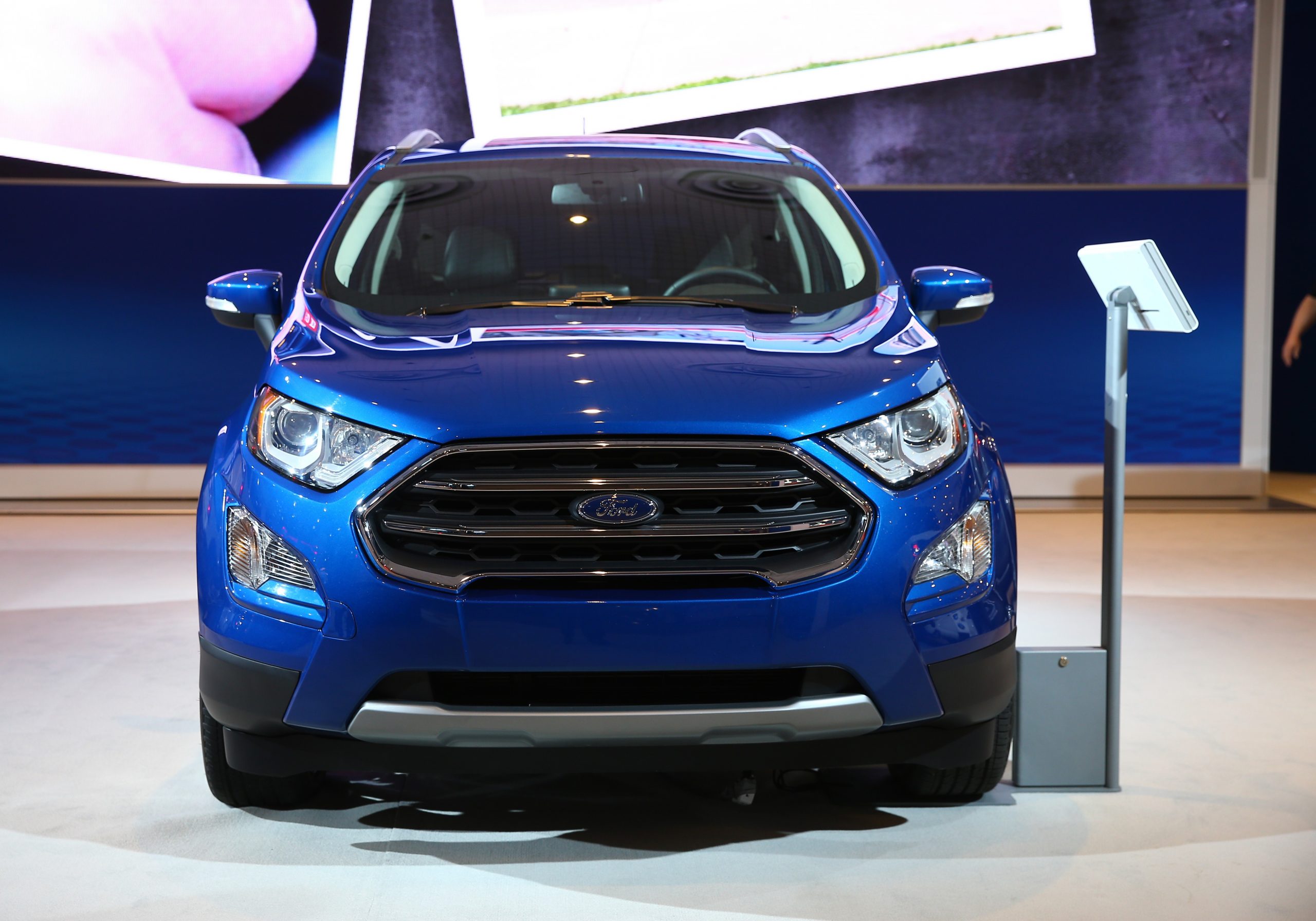 A blue Ford EcoSport on display at an auto show