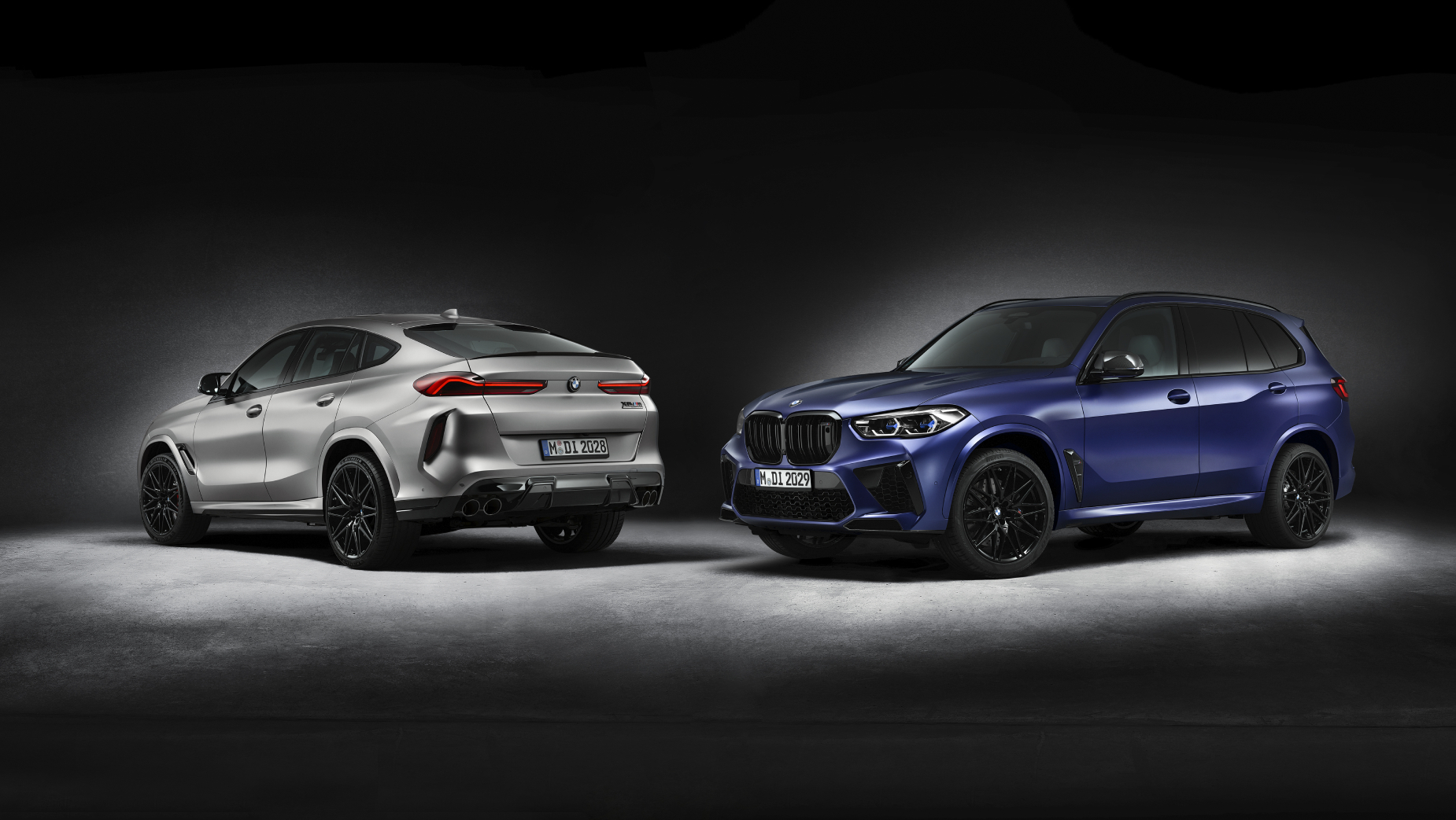 A silver 2020 BMX X6 M Competition First Edition and a blue 2020 BMW X5 M Competition First Edition posing side by side