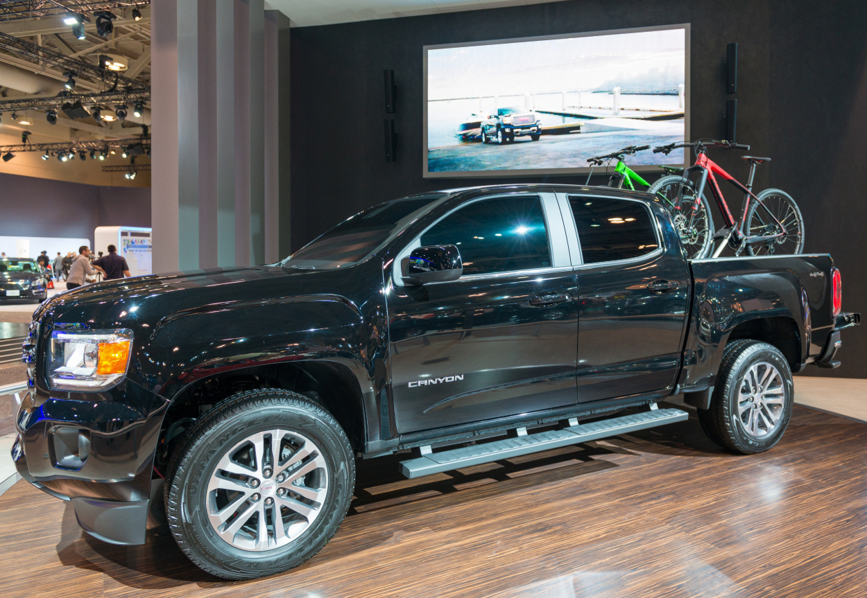 A black GMC Canyon on display at an auto show