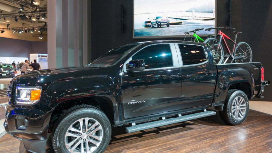 A black GMC Canyon on display at an auto show