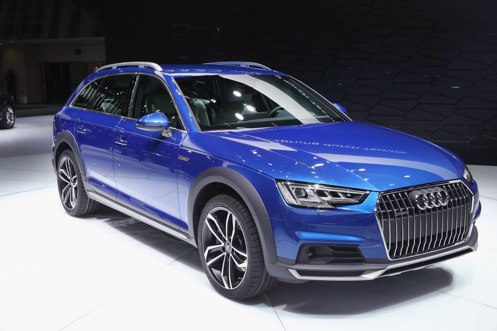 A blue Audi A4 Allroad wagon on display at an auto show