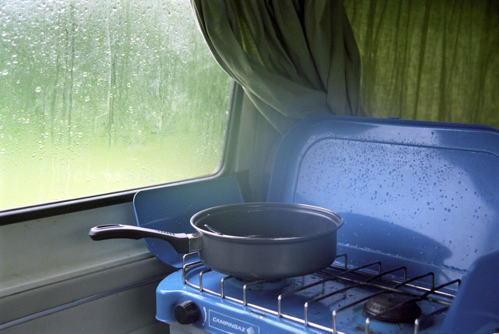 A saucepan on a blue camper van cooktop stove