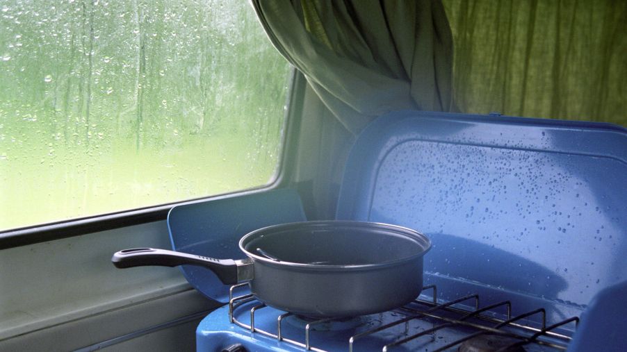 A saucepan on a blue camper van cooktop stove