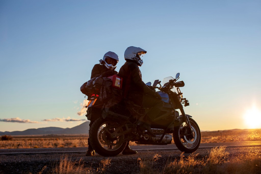 Charley Boorman organizes gear on Ewan McGregor's Harley-Davidson LiveWire