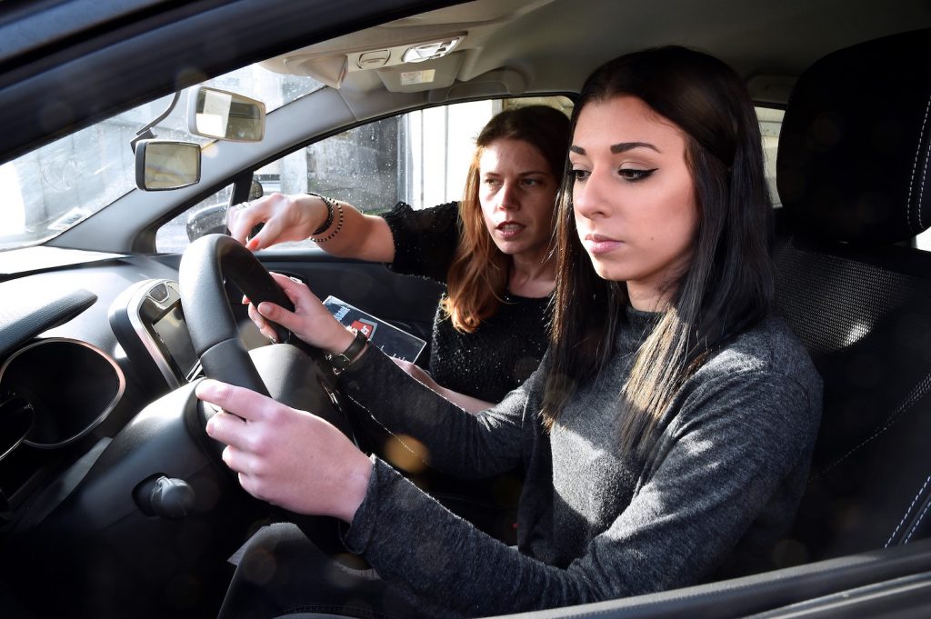 A teen driver in the middle of a driving lesson