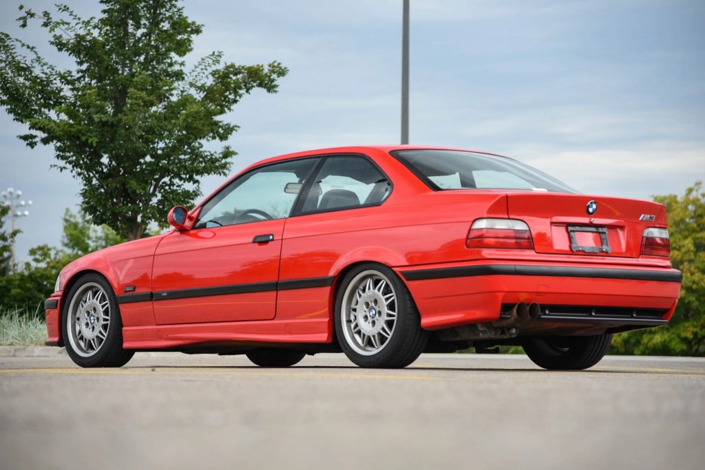 The rear 3/4 view of a red Euro-spec 1995 BMW M3 Coupe