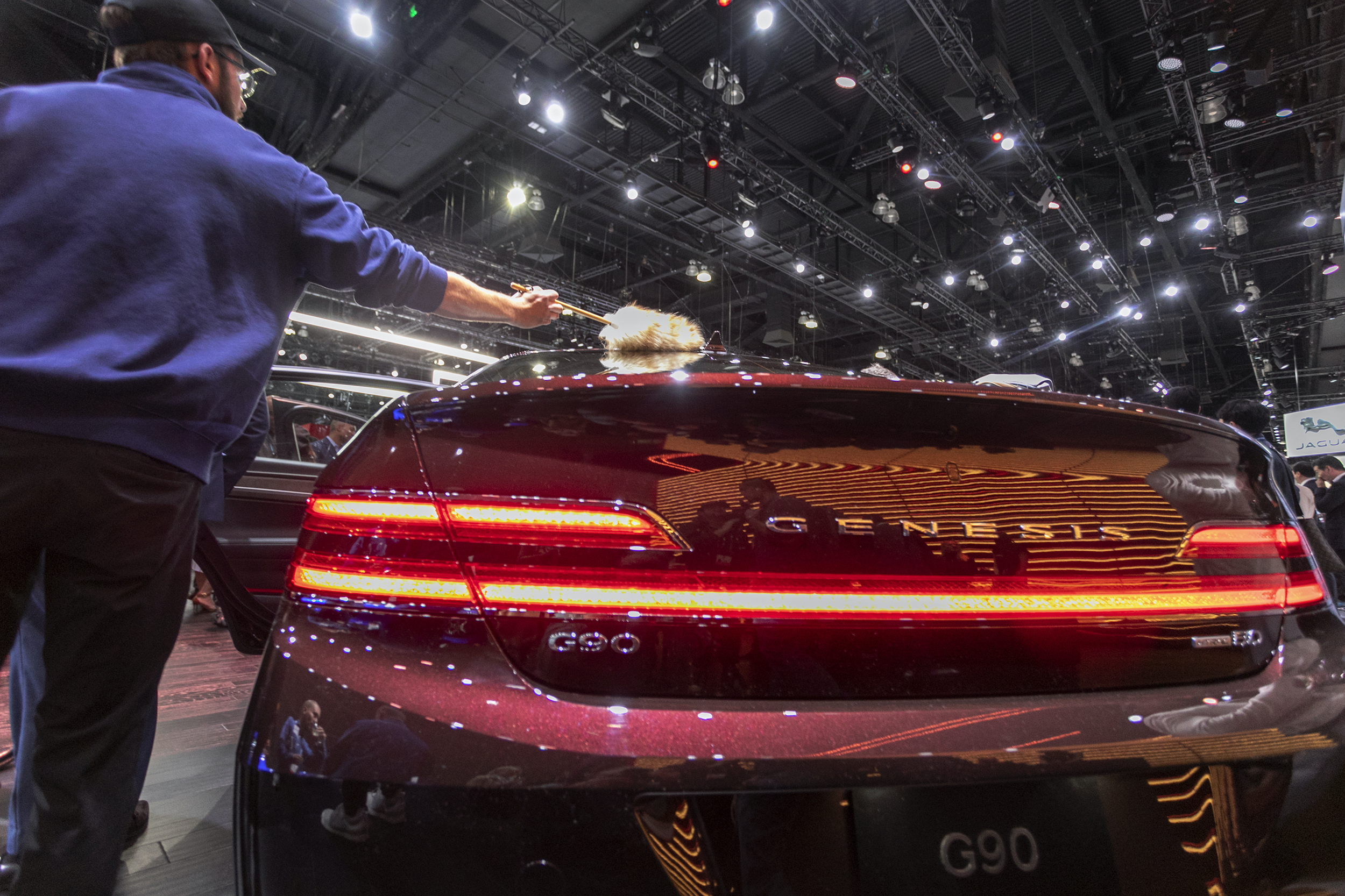 A man dusts the new-unveiled Genesis G90 at AutoMobility LA
