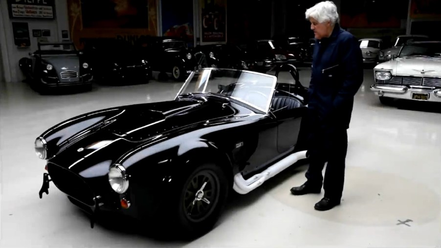 Jay Leno with a black 1965 Shelby Cobra 427 Competition