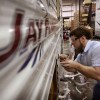 A worker at Jayco, Inc., the country's third largest maker of recreational vehicles, puts decals on a Jay Flight travel trailer