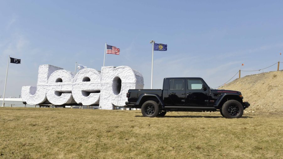 A Jeep Gladiator on display outside next to a Jeep sign