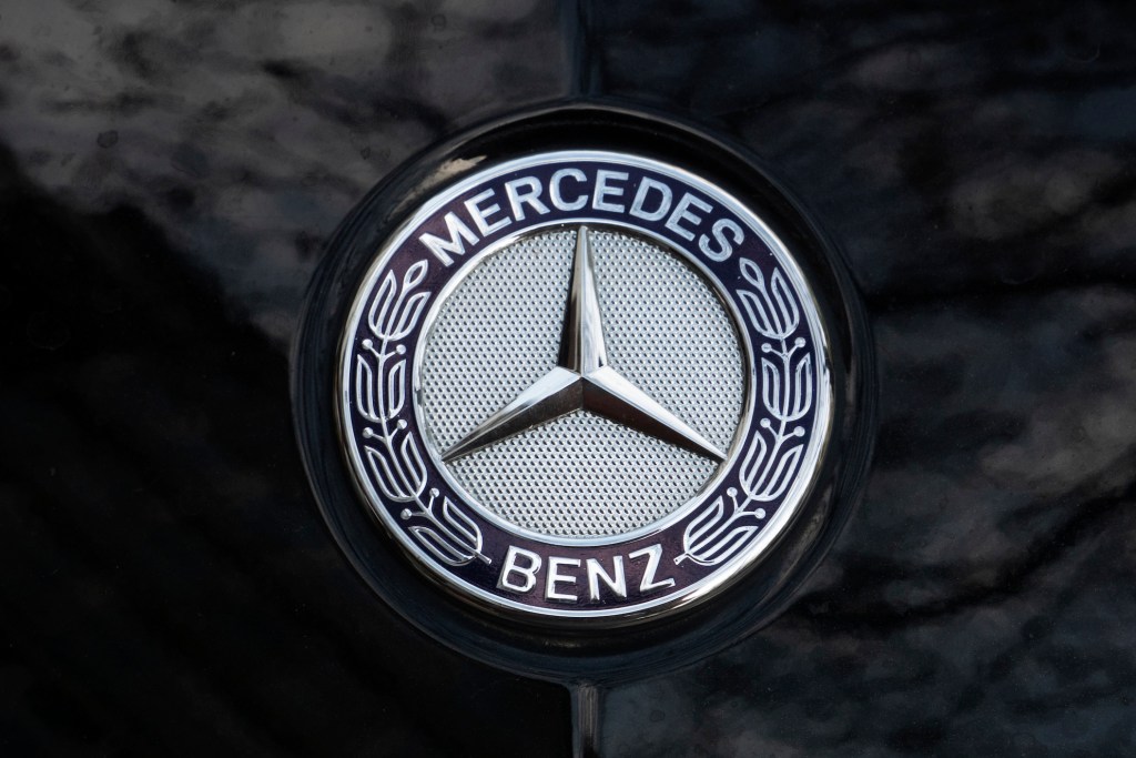 Mercedes-Benz logo seen on the hood of a black car.