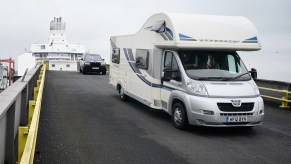 A motorhome RV drives down the exit ramp as travelers from France disembark from a Brittany Ferries ship