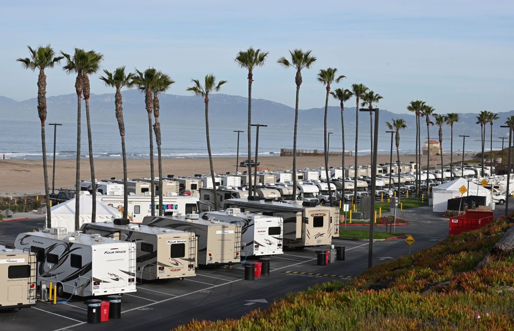 RVs parked at a lot by the ocean