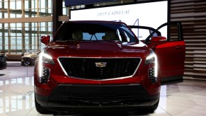 A red Cadillac XT4 on display at an auto show