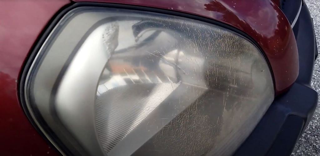 A headlight with stress cracks and fading.
