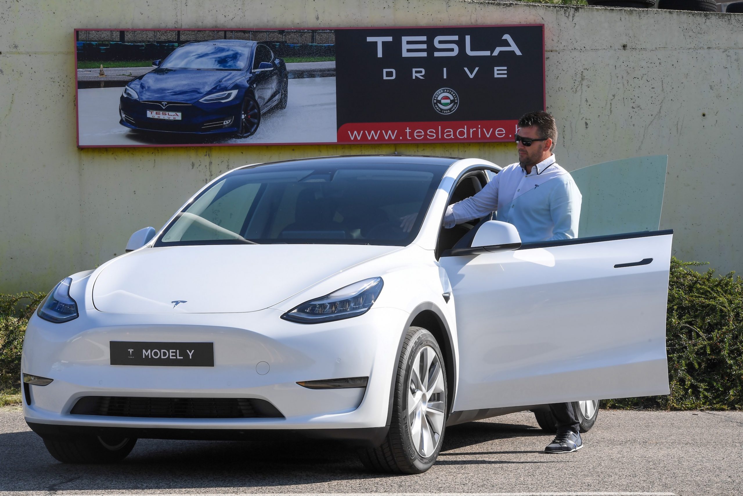 A picture taken on September 5, 2020 shows a driver testing a "Tesla Model Y" car, an all-electric compact SUV by US electric car giant Tesla