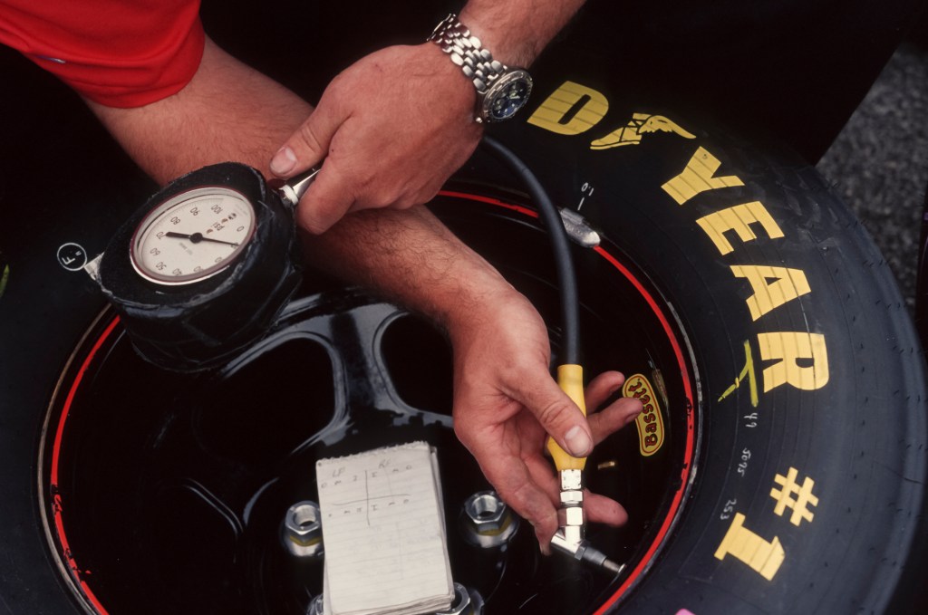 A tire gauge is being used to check pressure.