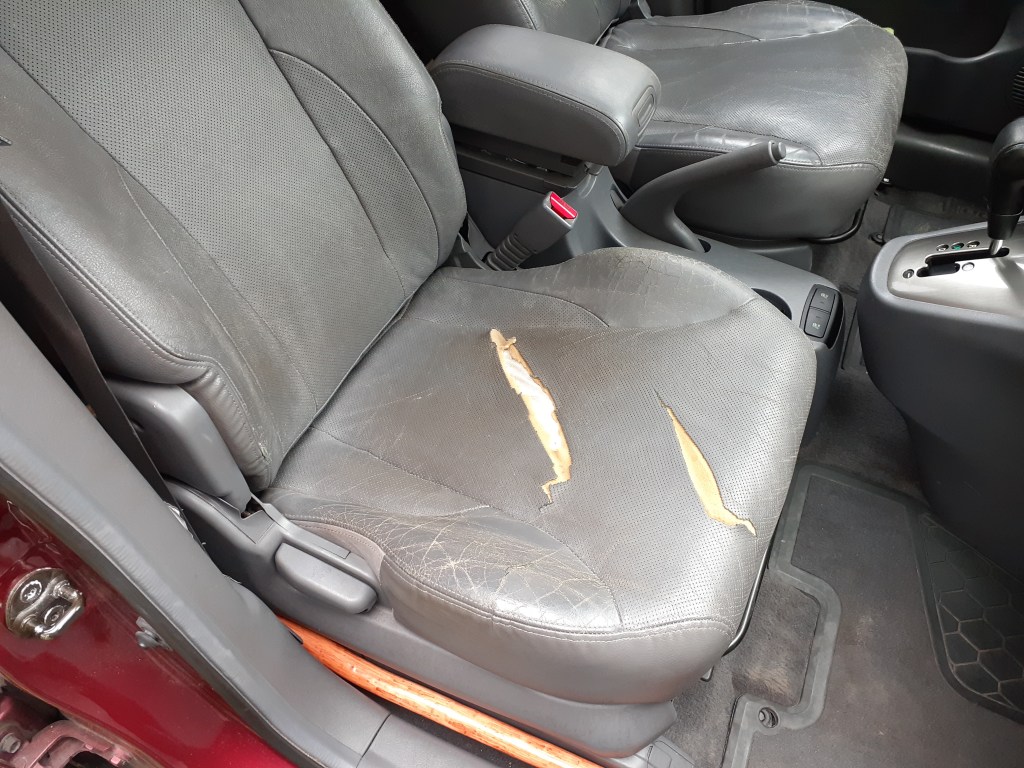The torn passenger seat of a 2005 Hyundai Tucson.