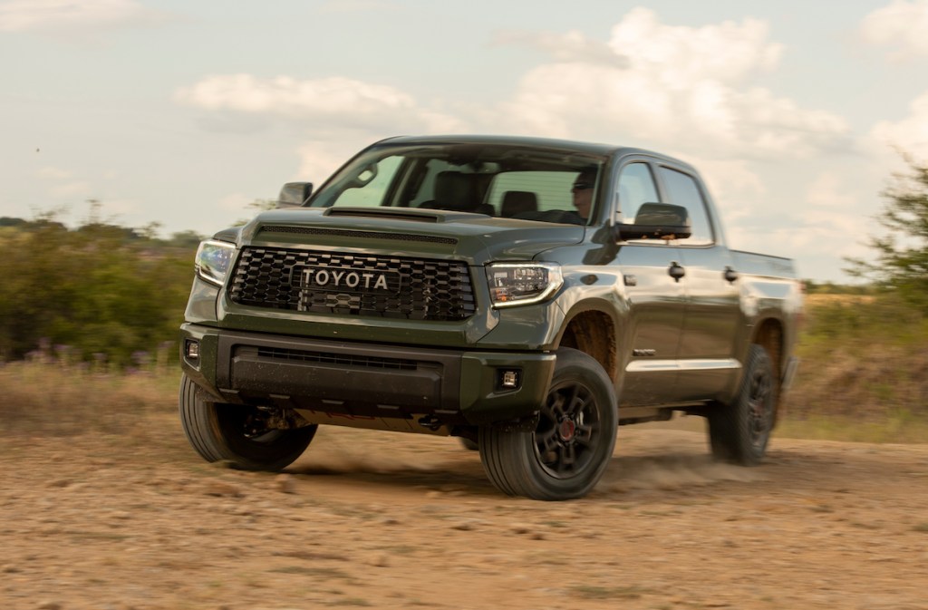 An army green Toyota Tundra off-roading