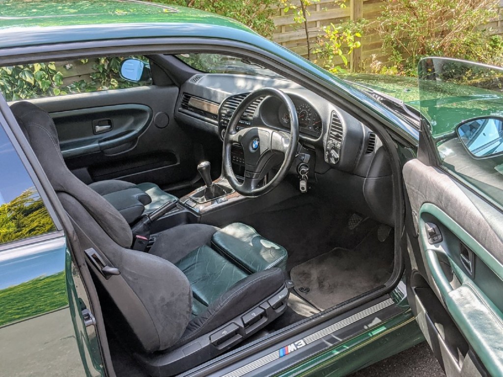 The green and carbon-fiber-trimmed interior of a UK-spec 1995 BMW E36 M3 GT