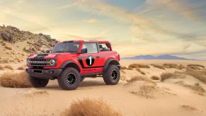 A red 2021 Hennessey Ford Bronco VelociRaptor on display in desert terrain