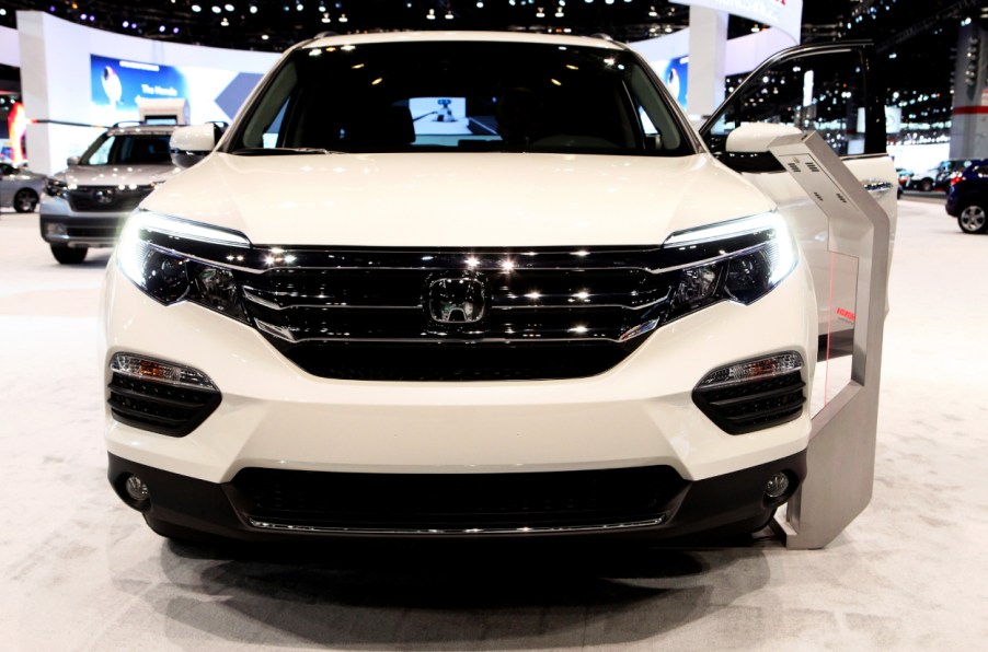 A white Honda Pilot on display at an auto show
