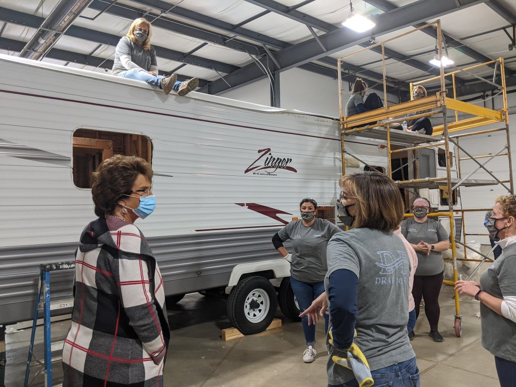 A Zinger Crossroads travel trailer RV is being renovated by a team of women working on the Drab-to-Fab program