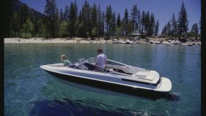 A Bayliner Maxum boat on crystal clear water.