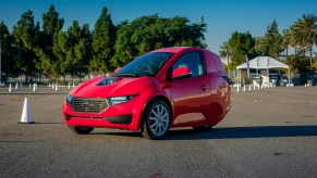 A red Solo, from ElectraMeccanica, sites in a parking lot.