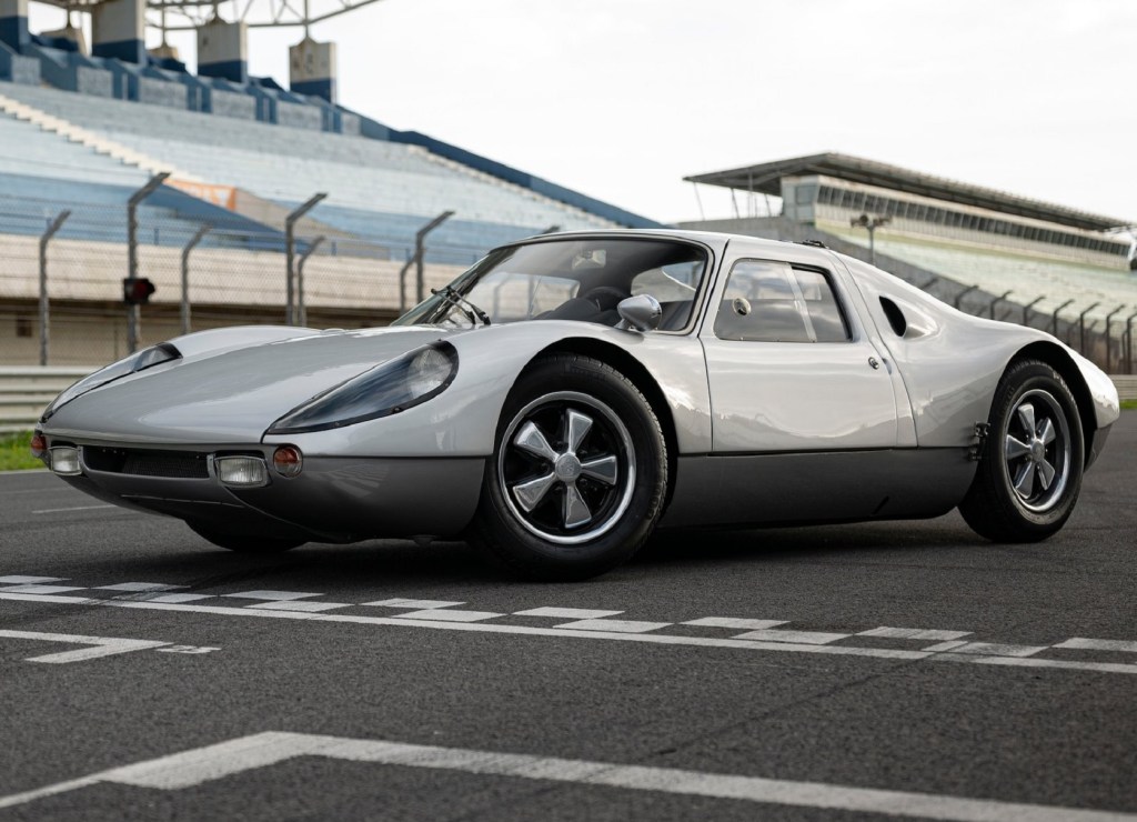 A silver-and-gray 1964 Porsche 904 Carrera GTS on a racetrack