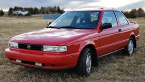 A red 1991 Nissan Sentra SE-R in a field