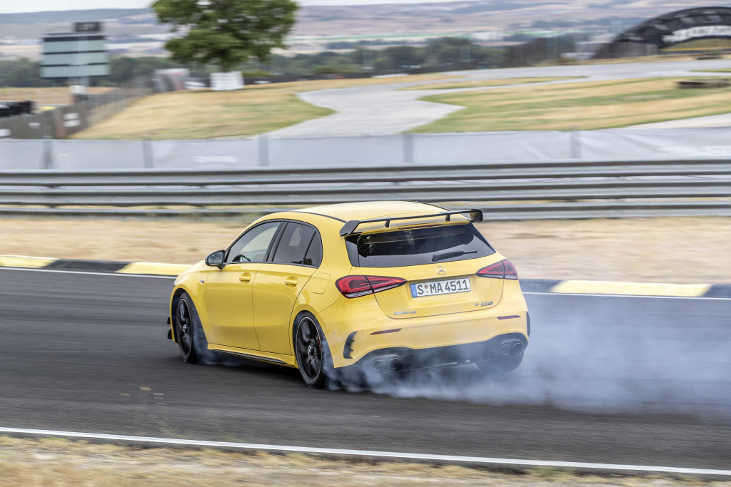 A photo of the Mercedes-AMG A 45 S utilizing its drift mode on track.