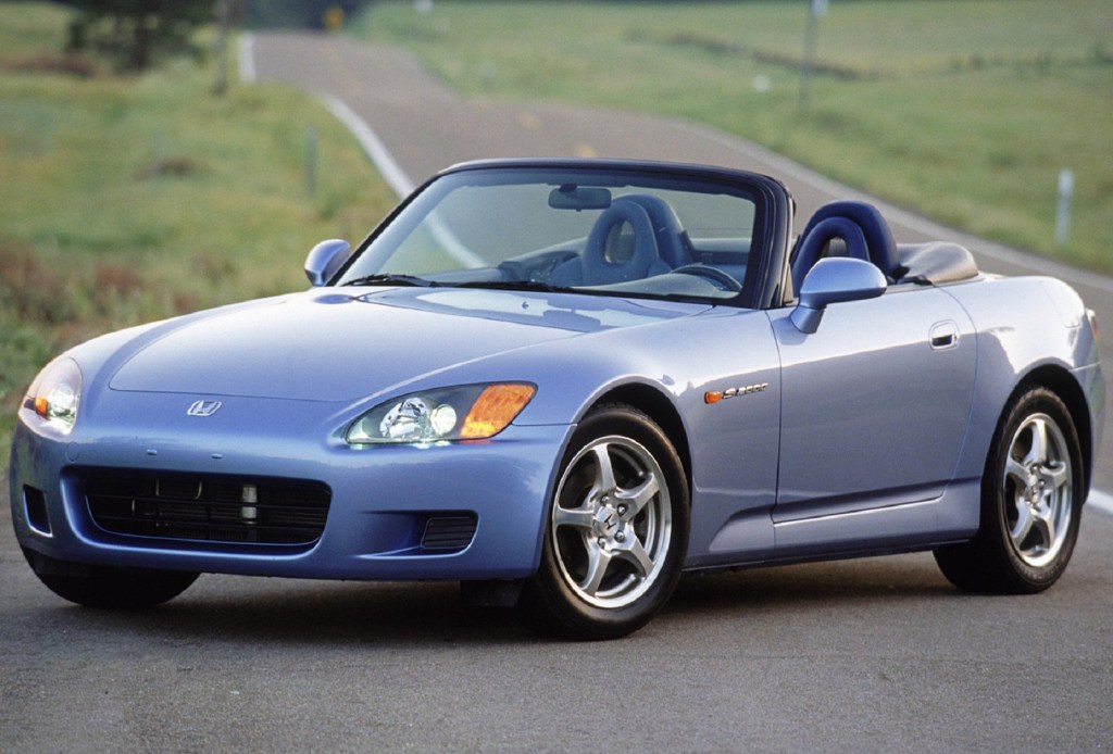 A blue 2002 Honda S2000 on a back-country road