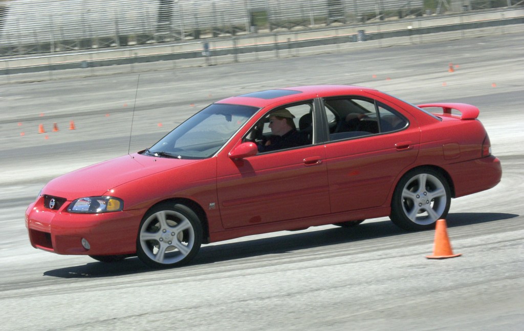 A red 2002 Nissan Sentra SE-R drives on an autocross course