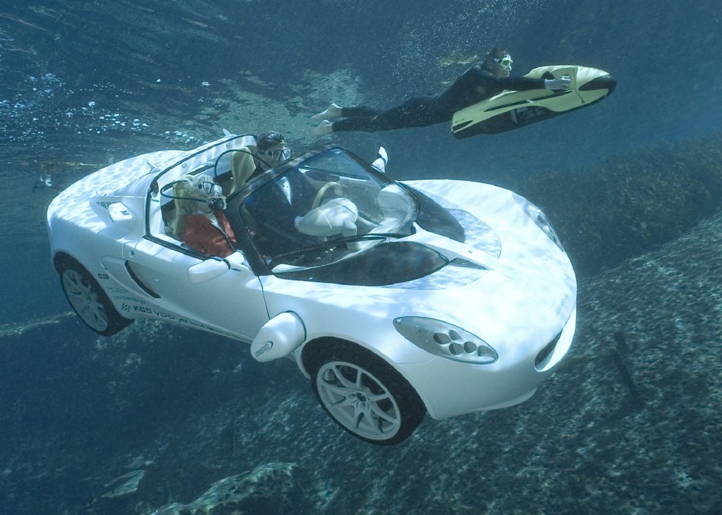 The white 2008 Rinspeed sQuba Concept floats through the ocean with a diver
