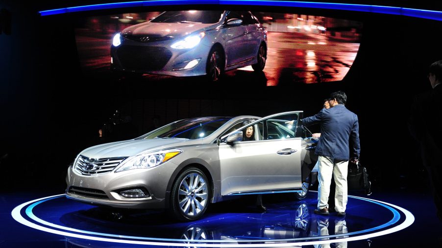 2012 Hyundai Azera parked on a stage with a woman getting out of the driver's seat