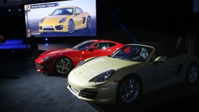 A Porsche Boxster/Cayman (R) sits on display after being named the 2013 World Performance Car of the Year at the New York Auto Show on March 28, 2013, in New York City.