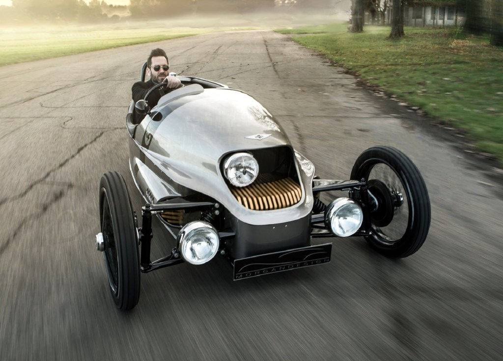 A silver 2017 Morgan EV3 drives on a track